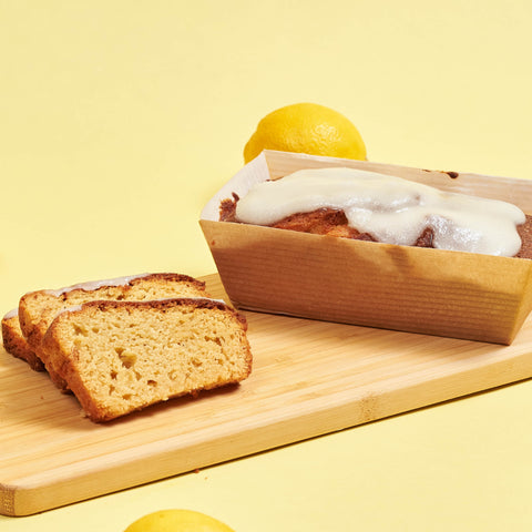 A slice of keto lemon bread on a wooden cutting board.