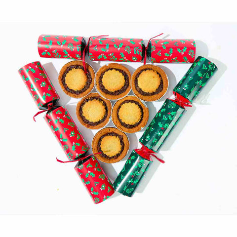 A group of No Guilt Bakes' Keto Mince Pies, with 6 pieces and no added sugars, and only containing 2.7 net carbs, are arranged in the form of triangular-shaped Christmas biscuits.