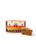 A piece of Low Carb Fruit Loaf Cake - Gluten Free, a popular Christmas treat by No Guilt Bakes, is sitting next to a box.